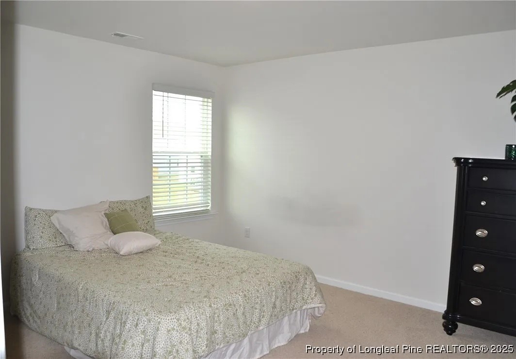 2153 Clydesmill Road Fayetteville, NC 28314 - Photo 9 of 16 a bedroom with a bed and window