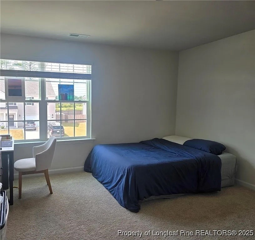 2153 Clydesmill Road Fayetteville, NC 28314 - Photo 10 of 16 a bedroom with a bed and a window