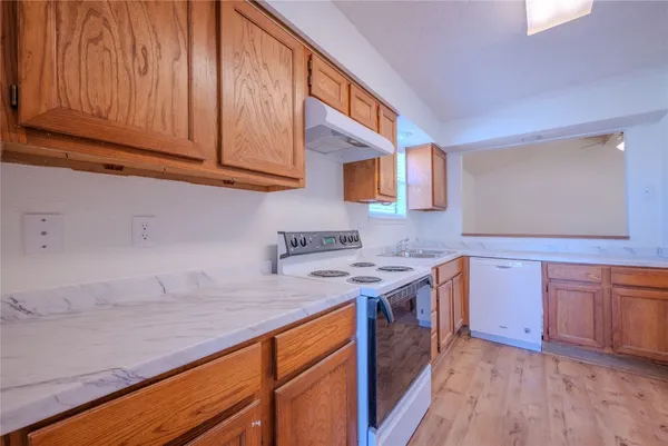 a kitchen with a sink stove and cabinets
