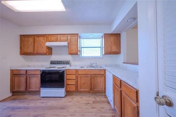 a kitchen with stainless steel appliances granite countertop a sink and a stove top oven