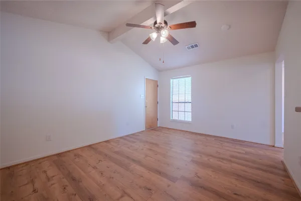 a view of an empty room with a window