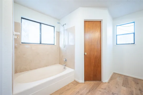 a bathroom with a bathtub and a shower
