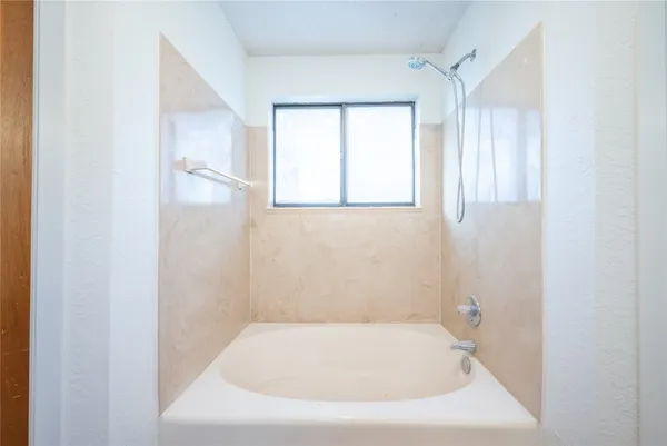 a white bath tub sitting in a bathroom