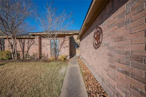 a view of a pathway along with wooden wall