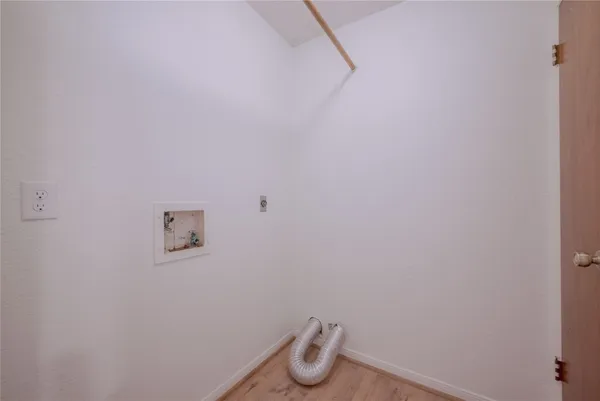 a room with wall dryer and white walls