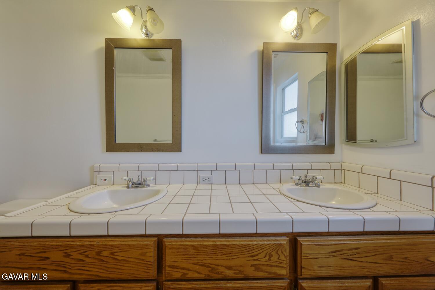 26801 Cabriolet Court Tehachapi, CA 93561 - Photo 27 of 60 a bathroom with a sink and a mirror
