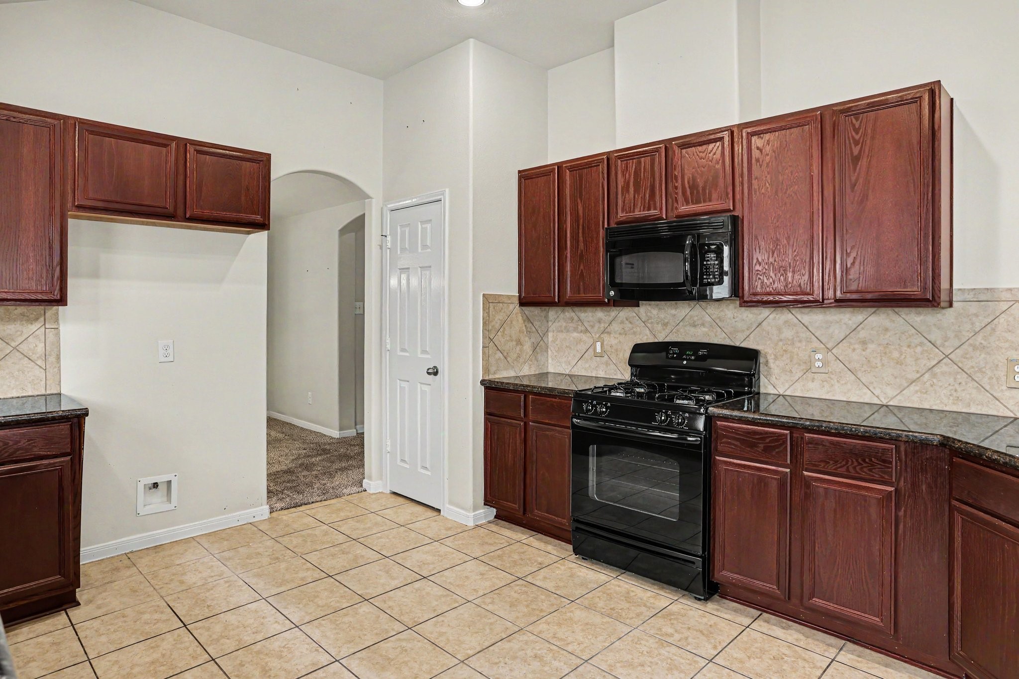 25222 Ginger Ranch Drive Katy, TX 77494 - Photo 9 of 33 Chefs kitchen with a gas range and microwave. Functional layout with ample storage and counter space.