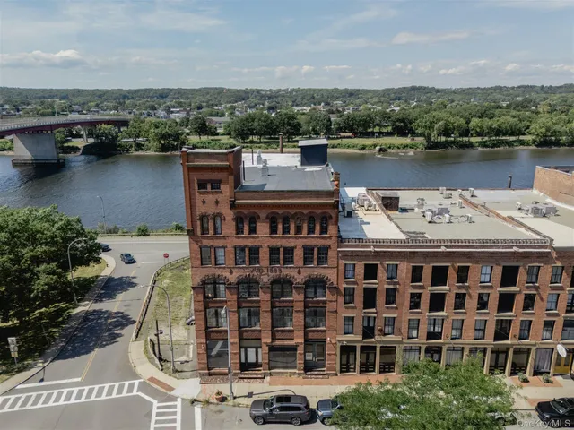 an aerial view of a house with outdoor space and lake view