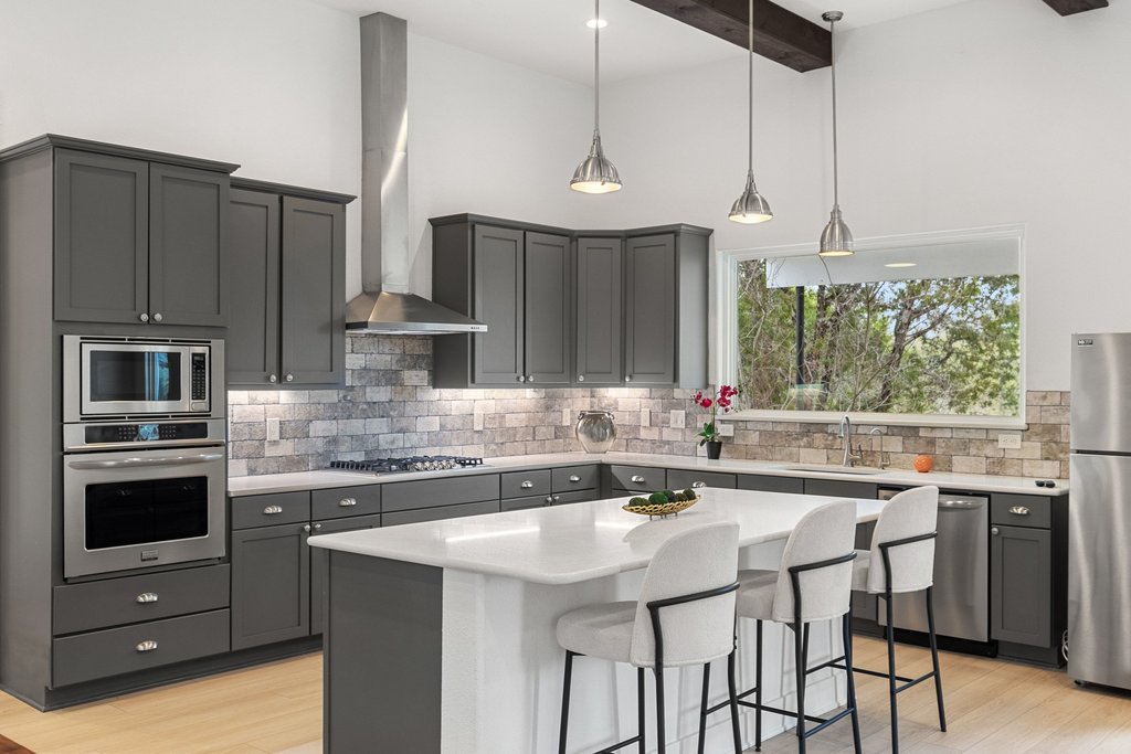 4018 Bee Creek Road Spicewood, TX 78669 - Photo 37 of 40 Guest house kitchen equipped with gas appliances, oven, microwave, dishwasher, and everything needed for full time living.