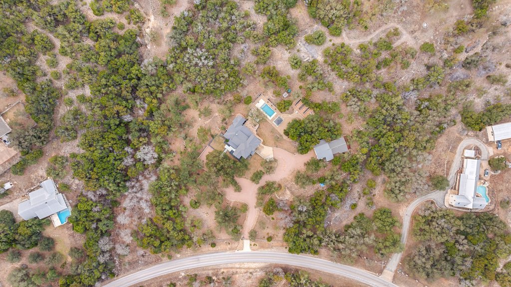 4018 Bee Creek Road Spicewood, TX 78669 - Photo 40 of 40 Aerial view showcasing the layout of the main house, guest house, outdoor living spaces and grounds.