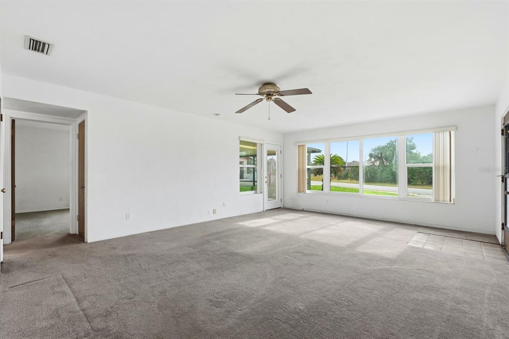 37 Berkley Road Ormond Beach, FL 32176 - Photo 11 of 41 an empty room with windows and ceiling fan