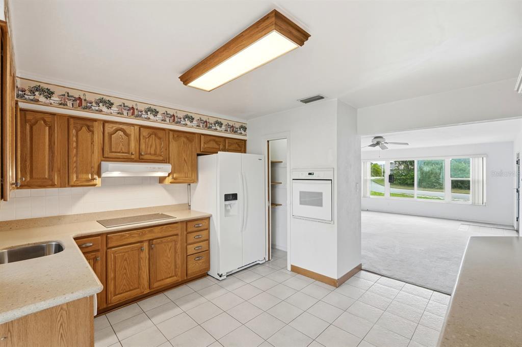 37 Berkley Road Ormond Beach, FL 32176 - Photo 14 of 41 a kitchen with white cabinets and white appliances