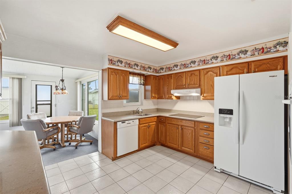 37 Berkley Road Ormond Beach, FL 32176 - Photo 16 of 41 a kitchen with stainless steel appliances a table and chairs
