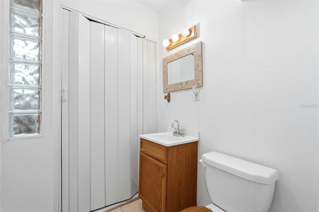 37 Berkley Road Ormond Beach, FL 32176 - Photo 19 of 41 a bathroom with a toilet sink vanity and mirror