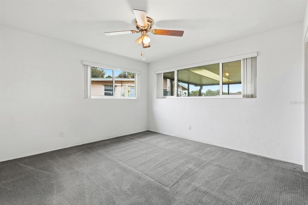 37 Berkley Road Ormond Beach, FL 32176 - Photo 23 of 41 an empty room with windows and ceiling fan