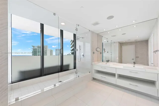 a view of spacious bathroom with a tub shower and sink