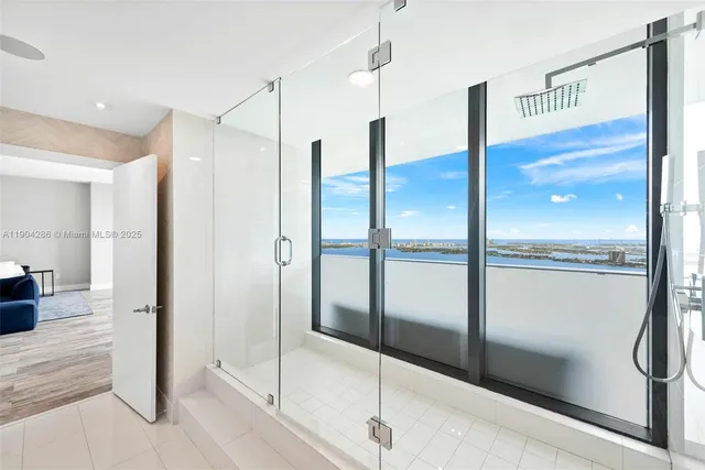 a bathroom with a shower and a glass door