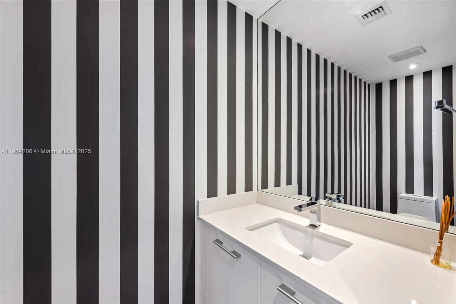 650 Northeast 32nd Street, Unit PH5201 Miami, FL 33137 - Photo 20 of 42 a bathroom with a sink and a mirror