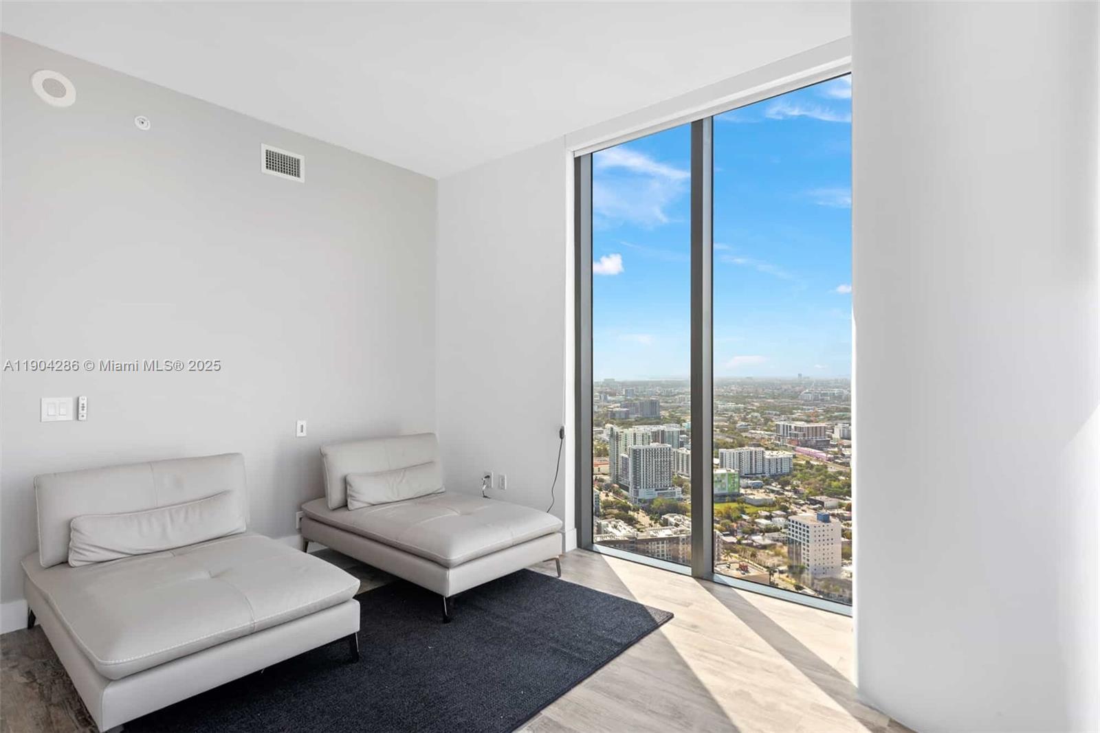 650 Northeast 32nd Street, Unit PH5201 Miami, FL 33137 - Photo 29 of 42 a living room with furniture and a floor to ceiling window
