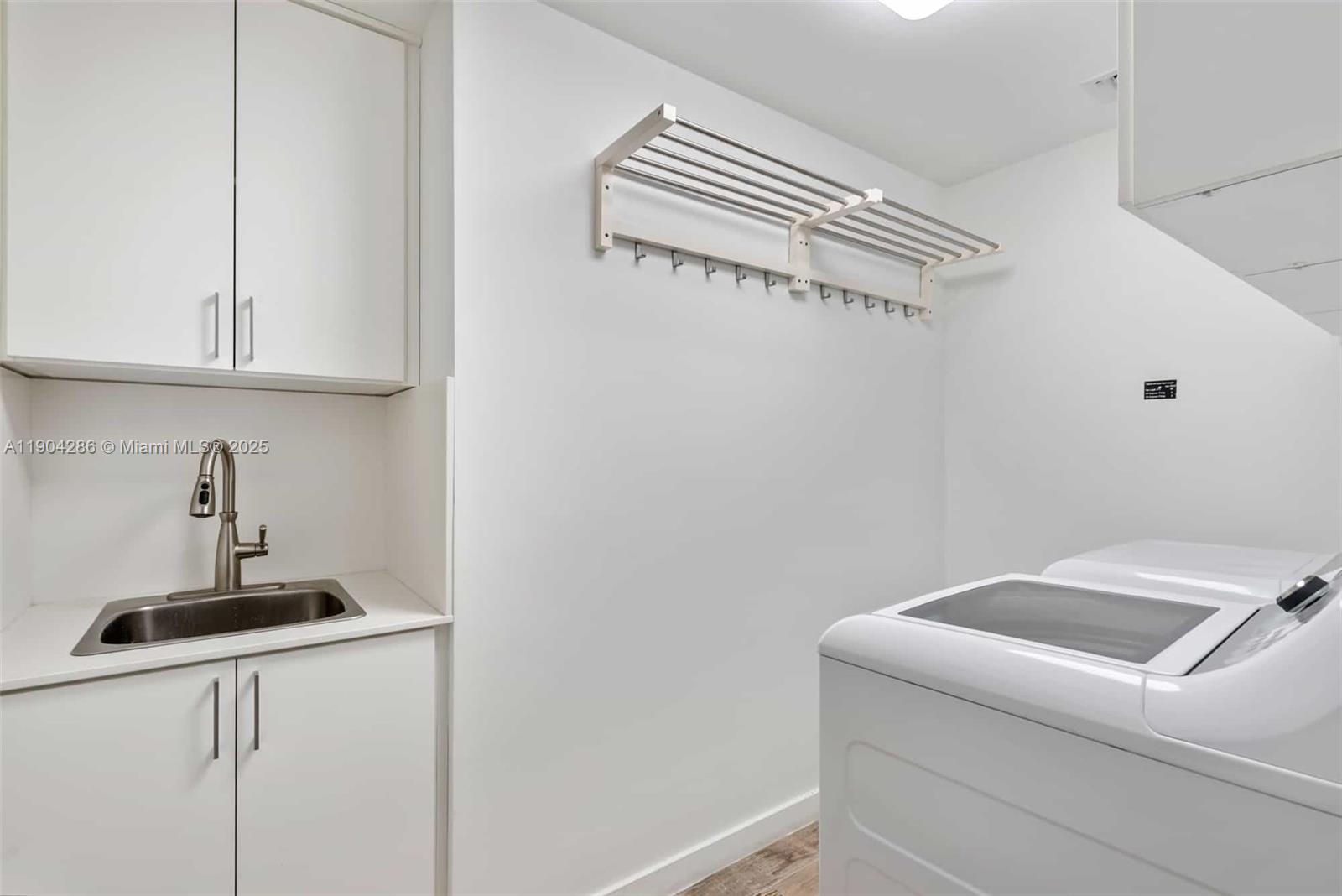 650 Northeast 32nd Street, Unit PH5201 Miami, FL 33137 - Photo 31 of 42 a bathroom with a sink and cabinets