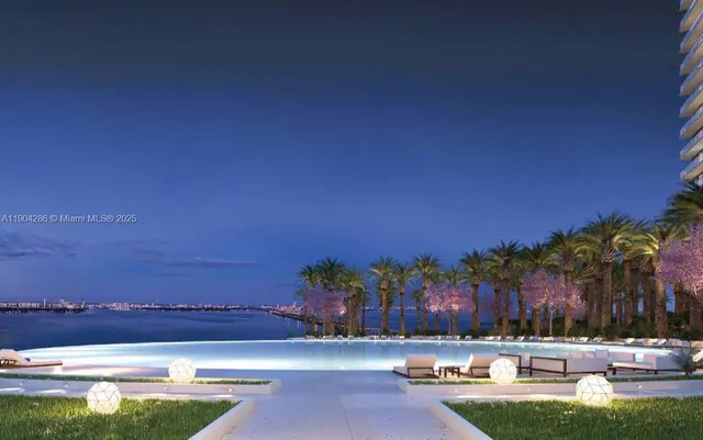 a view of a swimming pool with an outdoor seating and a kitchen