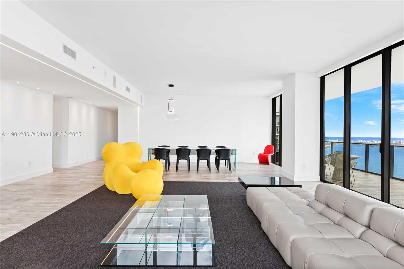 650 Northeast 32nd Street, Unit PH5201 Miami, FL 33137 - Photo 5 of 42 a living room with furniture and a flat screen tv