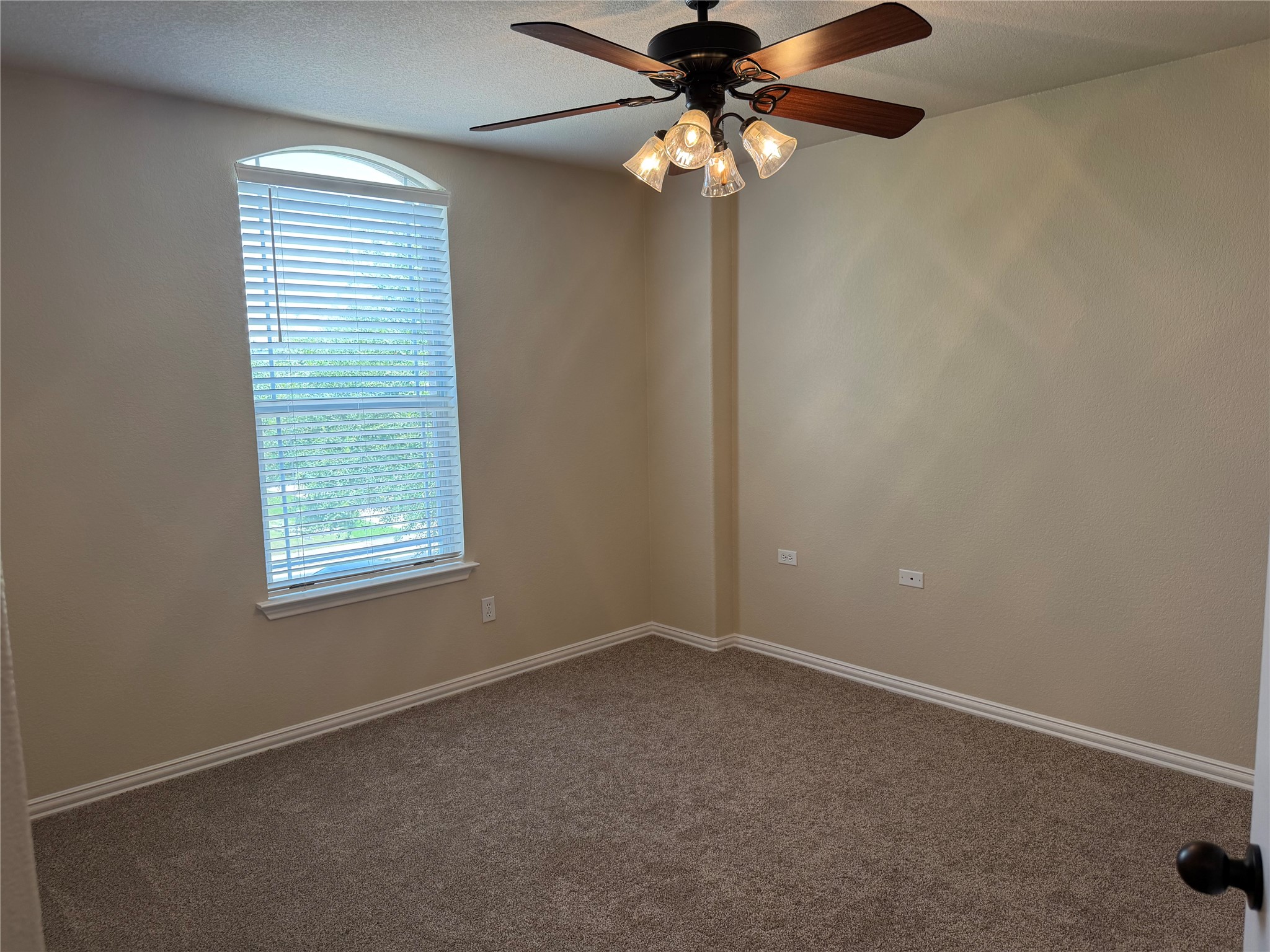 3021 Grand Mission Way Pflugerville, TX 78660 - Photo 29 of 31 Comfortable bedroom with neutral carpeting and a window offering outdoor views.