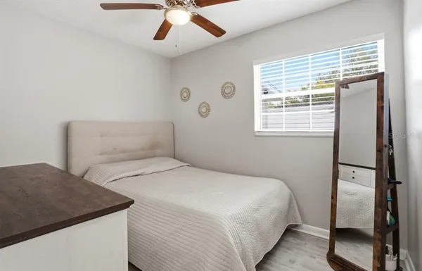 a bedroom with a large bed and a chandelier