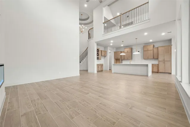 a view of large kitchen with stainless steel appliances refrigerator and microwave