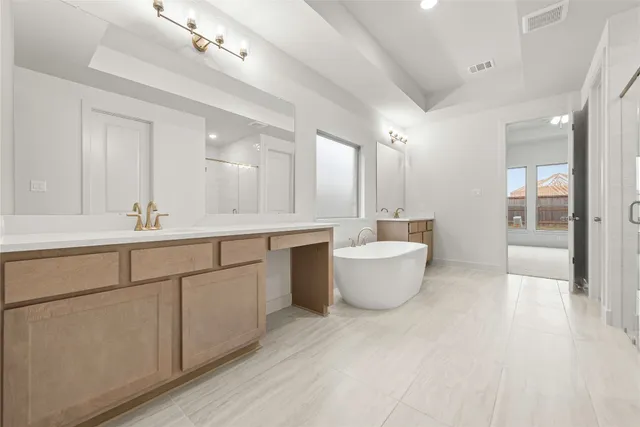 a large bathroom with a large tub sink and vanity