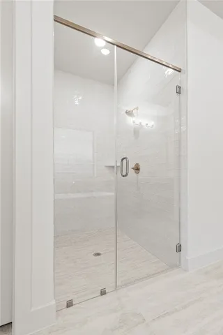 a bathroom with a glass shower door
