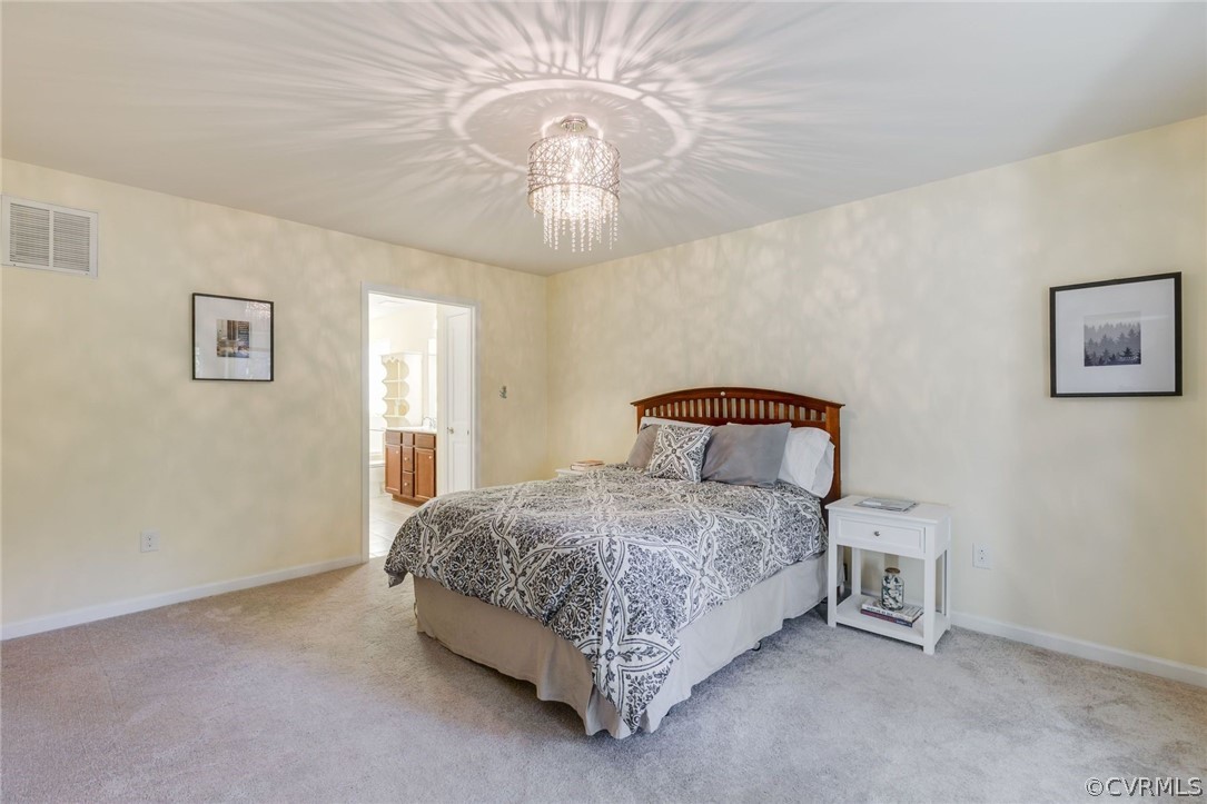 10331 Sandy Ridge Drive Chesterfield, VA 23832 - Photo 11 of 39 a spacious bedroom with a bed and a chandelier
