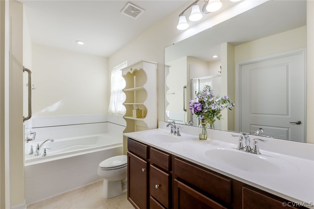 10331 Sandy Ridge Drive Chesterfield, VA 23832 - Photo 13 of 39 a bathroom with a double vanity sink toilet mirror and bathtub