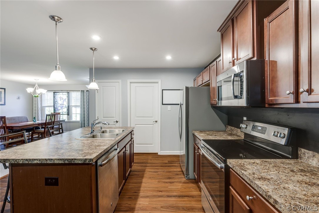 10331 Sandy Ridge Drive Chesterfield, VA 23832 - Photo 8 of 39 a kitchen with stainless steel appliances granite countertop a sink a stove and a wooden floors