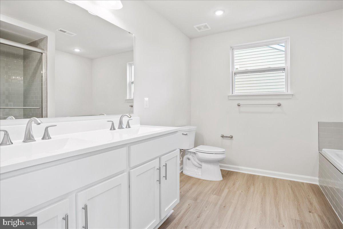 434 Freeman Street Ranson, WV 25438 - Photo 13 of 26 a bathroom with a granite countertop sink toilet a large mirror and shower