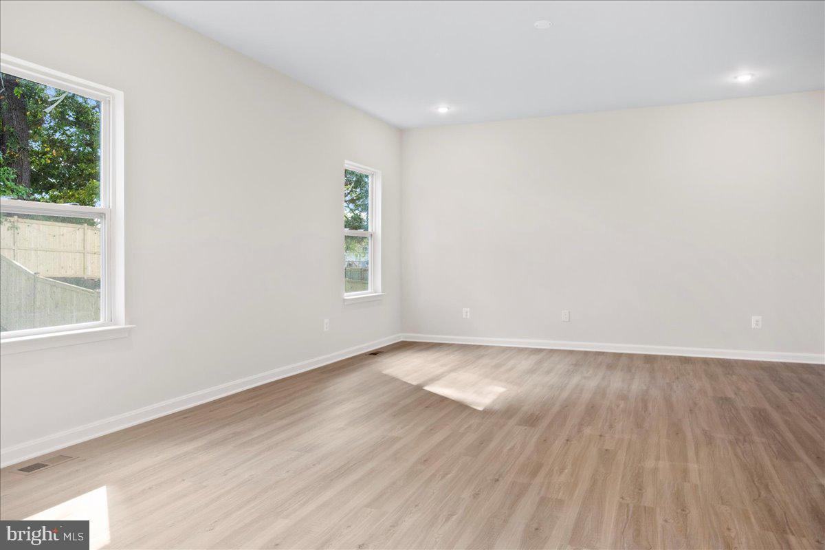 434 Freeman Street Ranson, WV 25438 - Photo 18 of 26 an empty room with wooden floor and windows