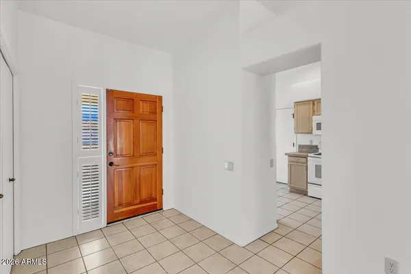 a view of an empty room with window and cabinet