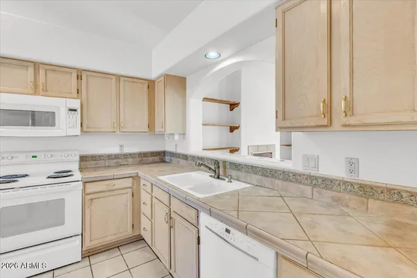 a view of a kitchen with white cabinets