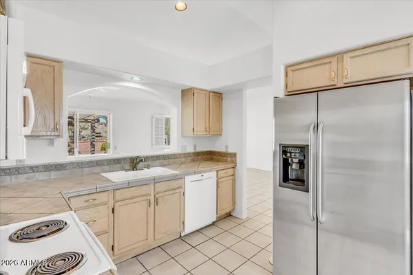 a view of a kitchen with cabinets and a window