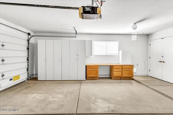 a small space with a ceiling fan and stairs