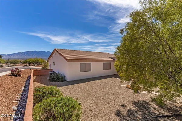 a backyard of a house with basket ball court and outdoor seating