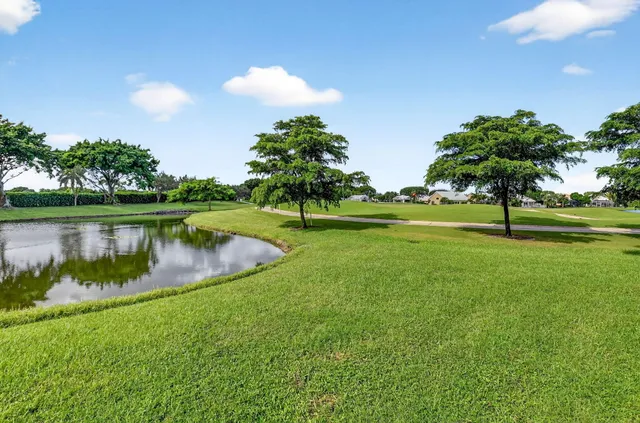 an aerial view of a house with a lake view and a large pool