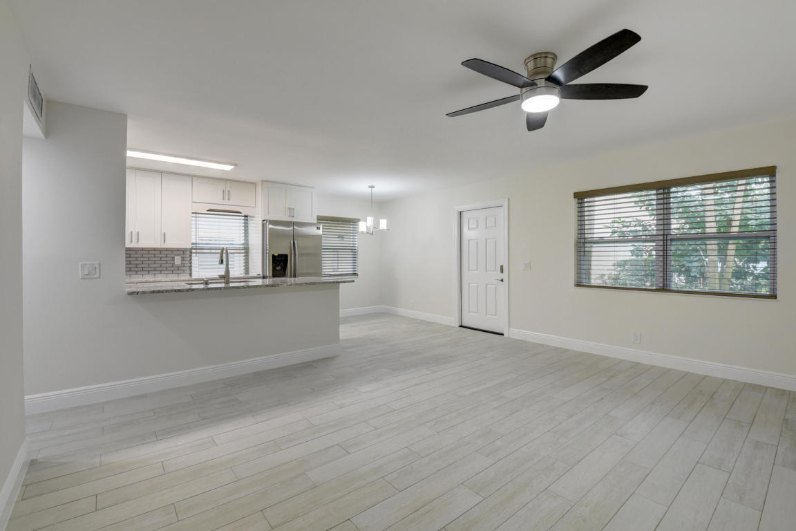 76 Flanders B Delray Beach, FL 33484 - Photo 10 of 35 wooden floor in an empty room with a window