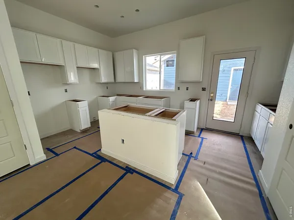 a view of a kitchen with a sink a microwave and cabinets