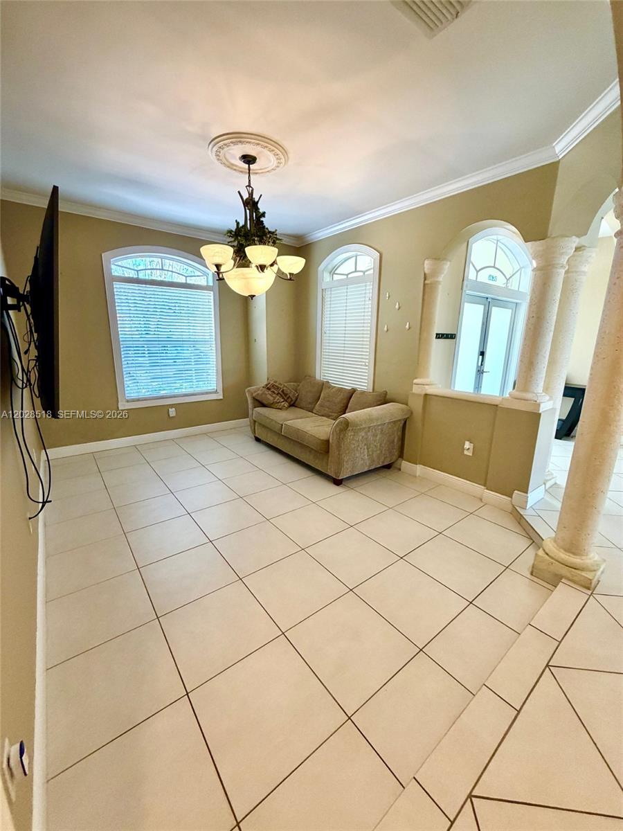 9444 Southwest 78th Street Miami, FL 33173 - Photo 4 of 11 a living room with a couch and chandelier