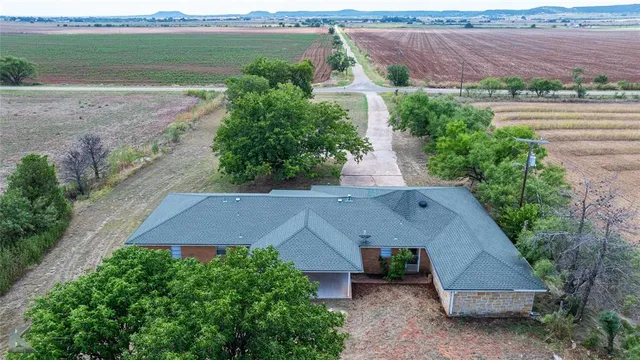 a view of a lake with a garden from a terrace