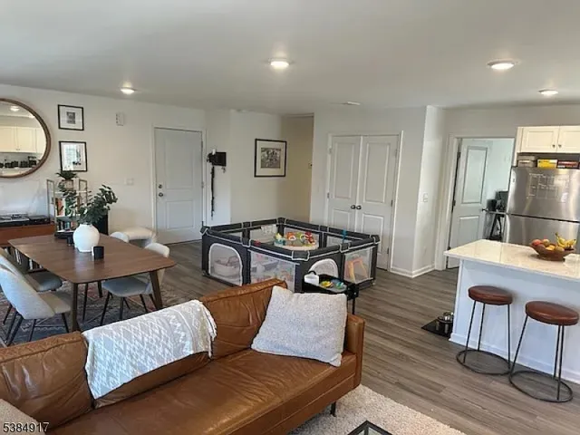 a living room with furniture and wooden floor