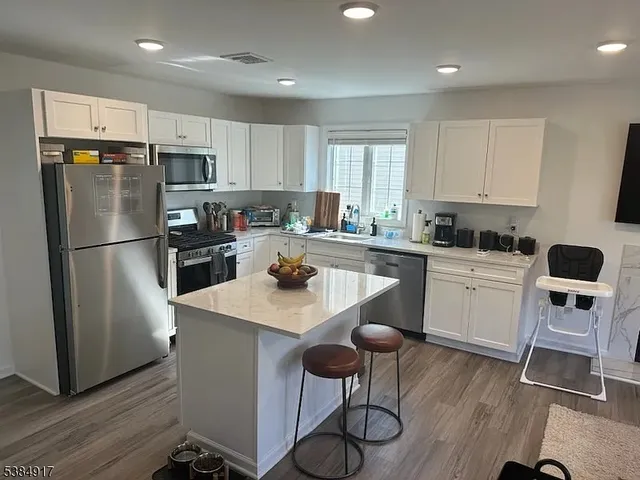 a kitchen with stainless steel appliances a refrigerator stove microwave and cabinets