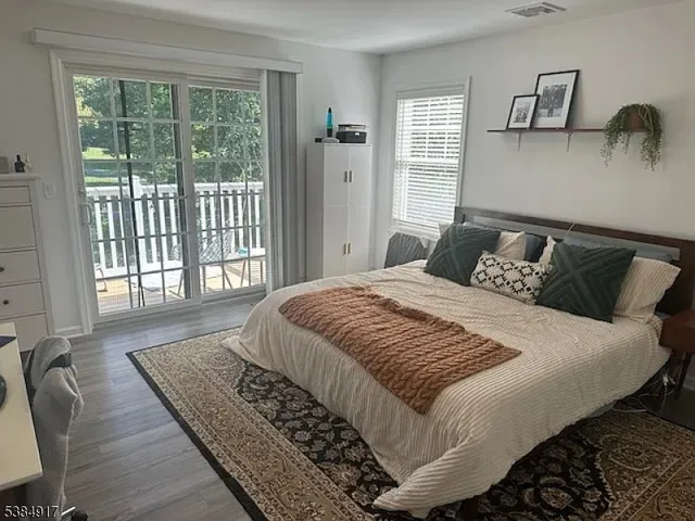 a bedroom with a bed and glass window