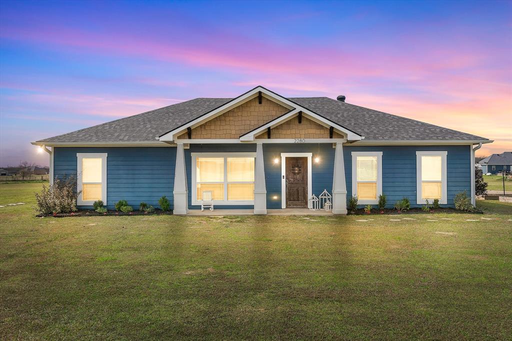 a front view of a house with yard